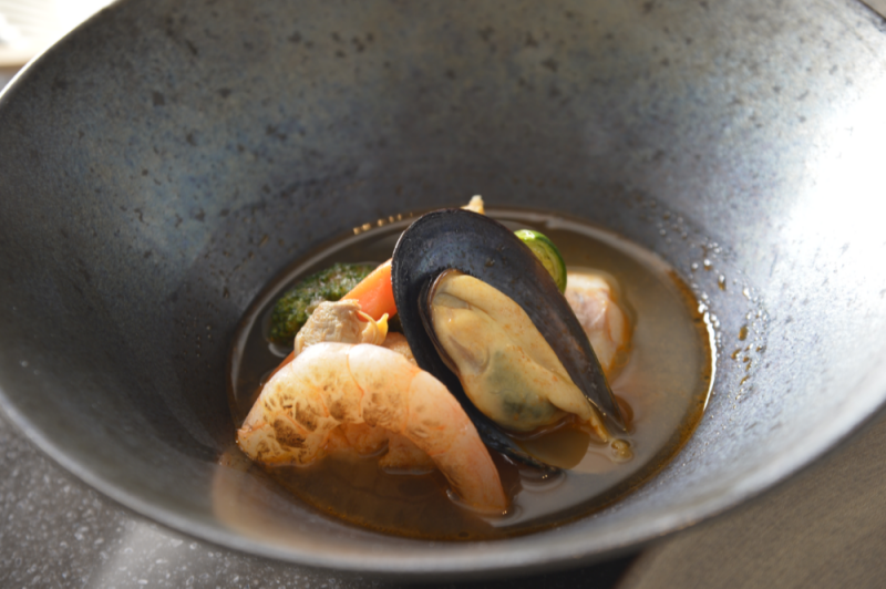 Pacific cod and shrimp crustacean soup with mussels vongole and grilled vegetables